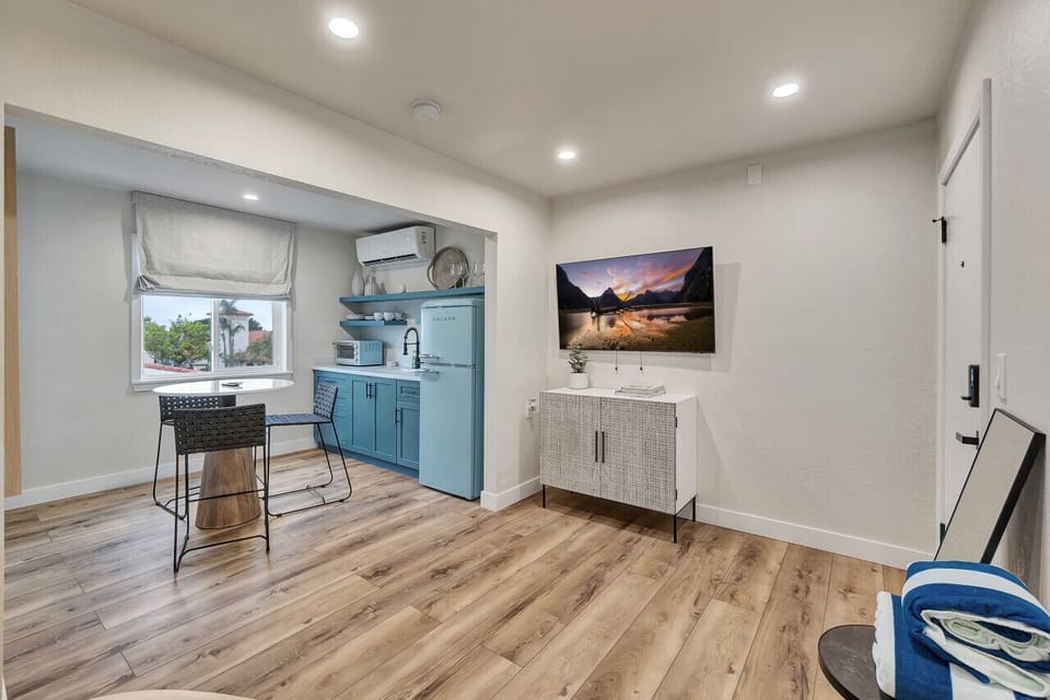 Open living space blending kitchen, dining & lounge areas w/ TV for laid-back evenings
