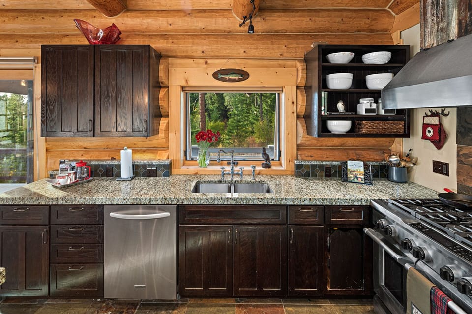 Main lodge kitchen with 6-burner gas range, 2 ovens, microwave, dishwasher.