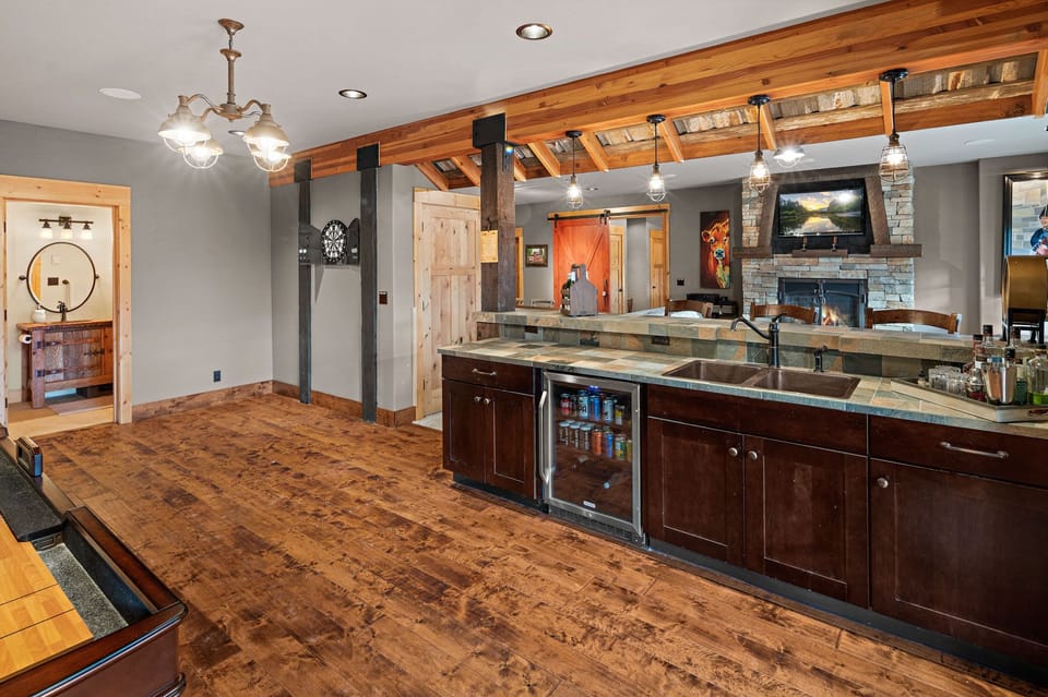 Main lodge bar, mini fridge, and prep sink on lower level.