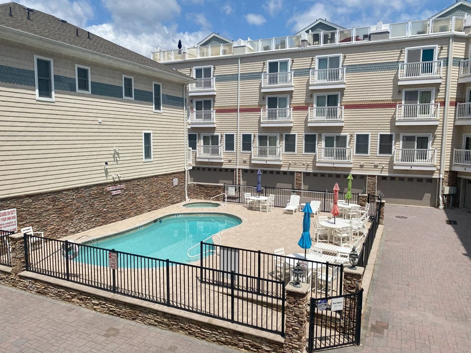 View of community pool from kitchen balcony