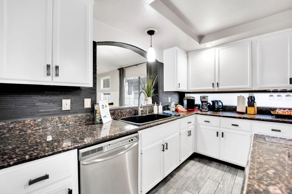 A large kitchen sink and dishwasher with plenty of storage!