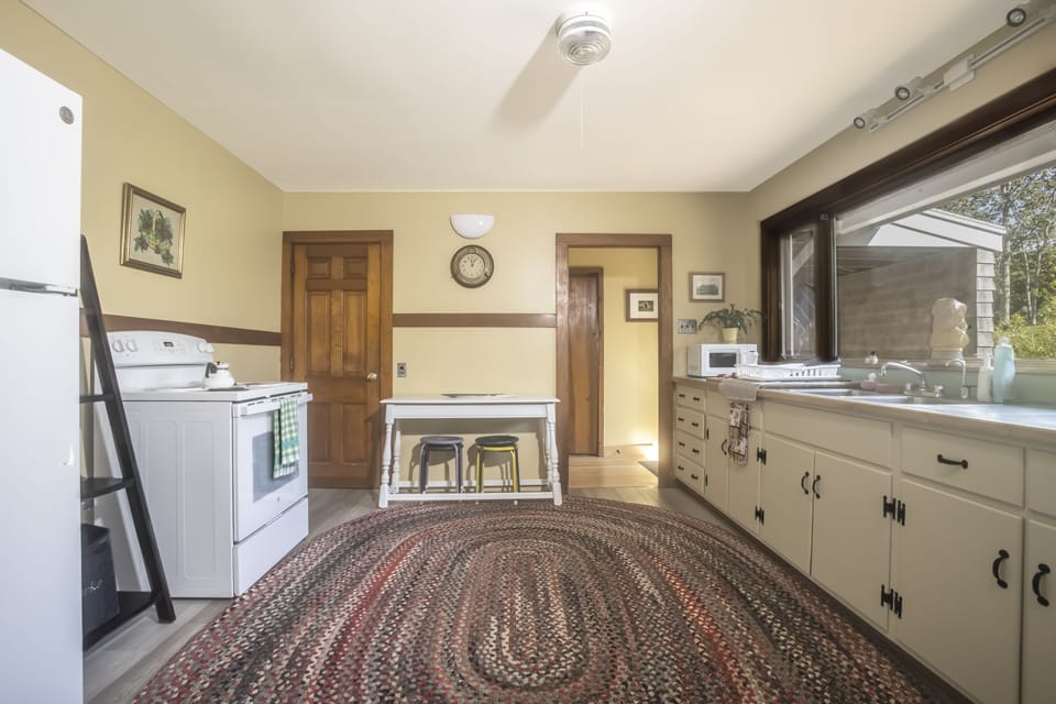 Full kitchen overlooking open space.