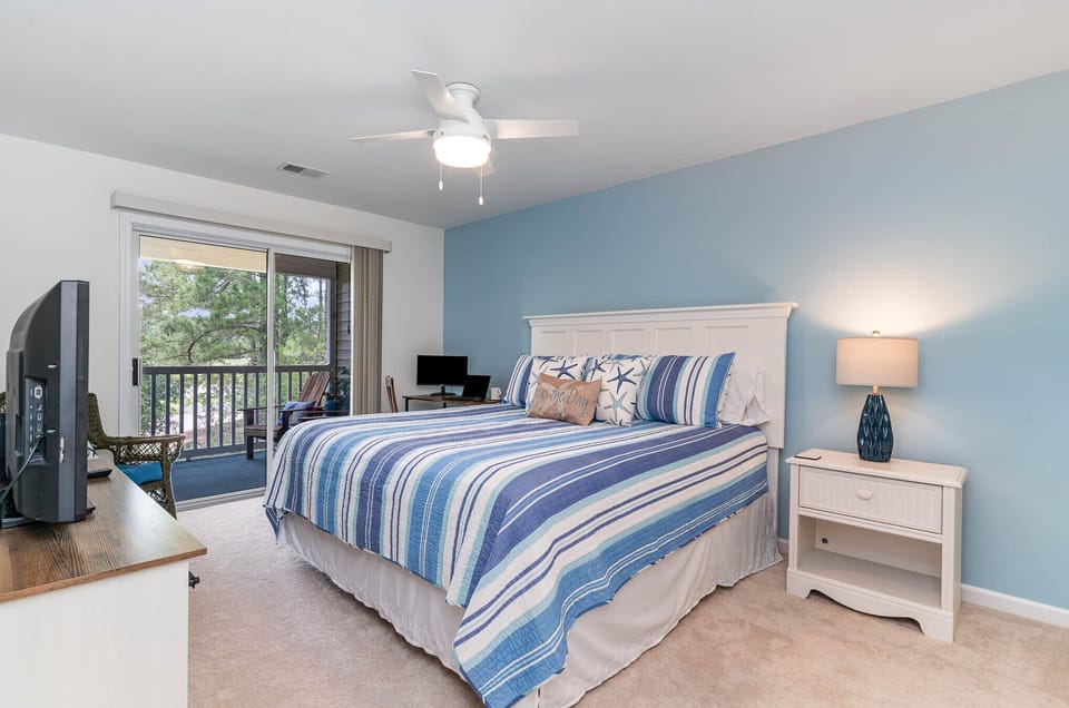 Master Bedroom with desk workstation and monitor and access to balcony