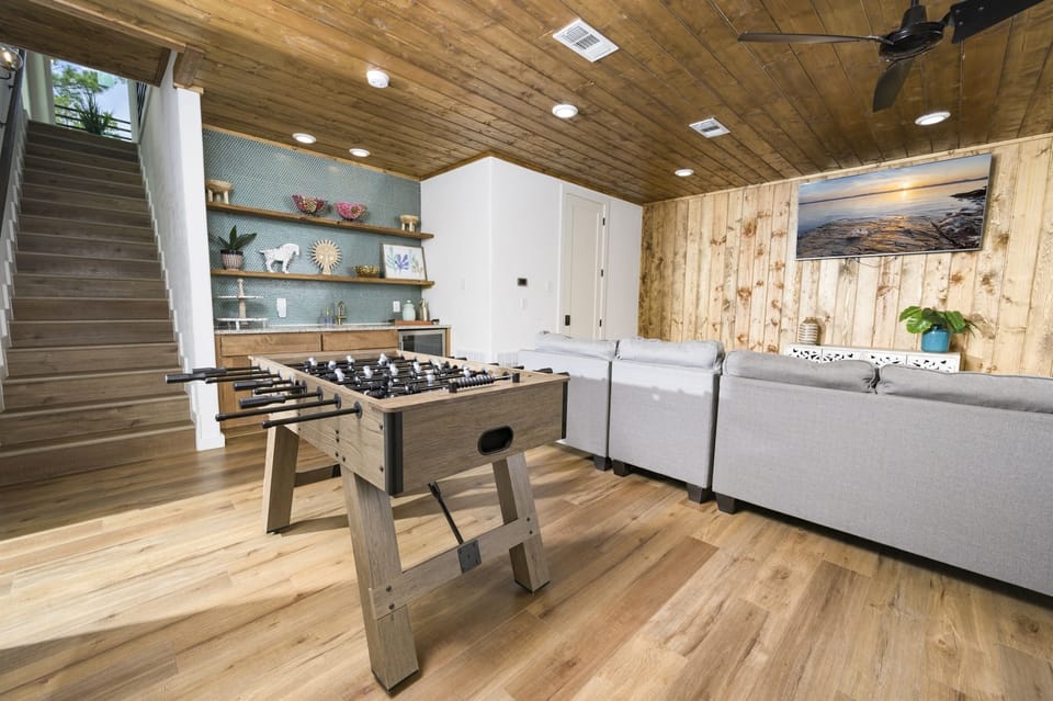 A foosball table and a game table finish out the game room.