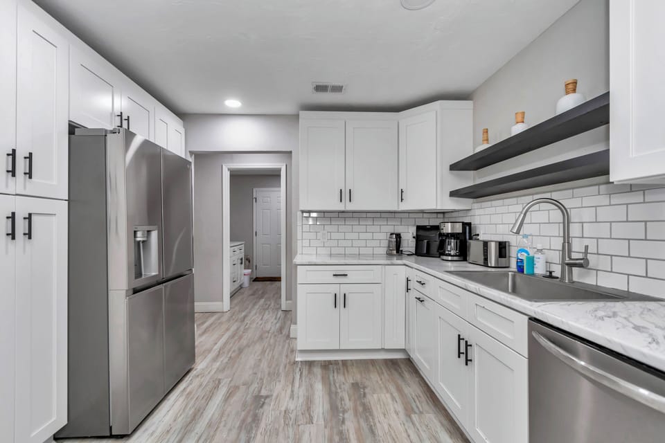 Upgraded kitchen, wine/coffee nook, recessed lights, newer appliances, pots/pans