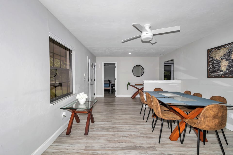 Dining room by kitchen/family room, seating for 8, windows, ceiling fan & open.