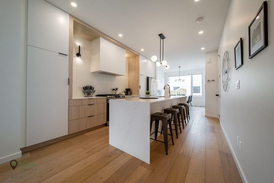 Open concept kitching with bar stool seating and long island