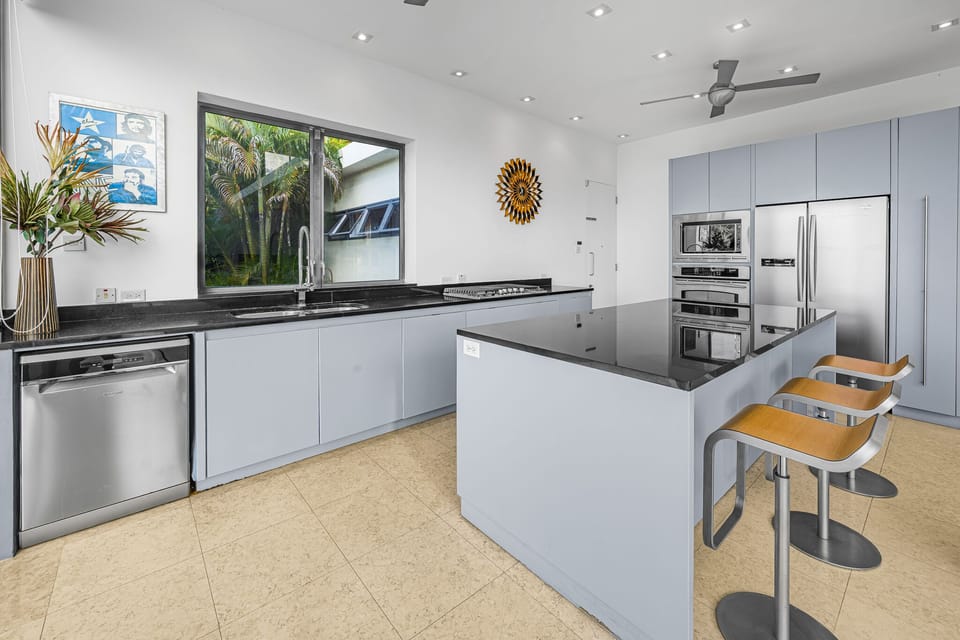 Modern fully fitted kitchen with bar seating
