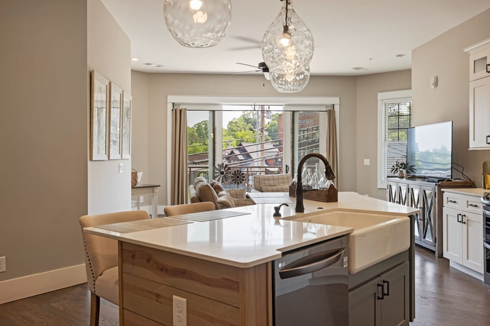 Modern open kitchen w/ stainless steel appliances & granite island seating for 4