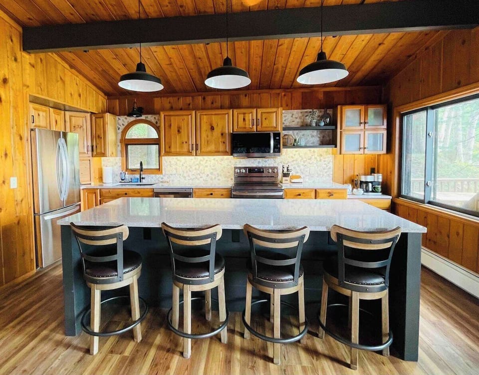 Kitchen with all new appliances.  The large island has seating for 8 with stools on both sides.  Great area for cooking, prepping, or just gathering. 