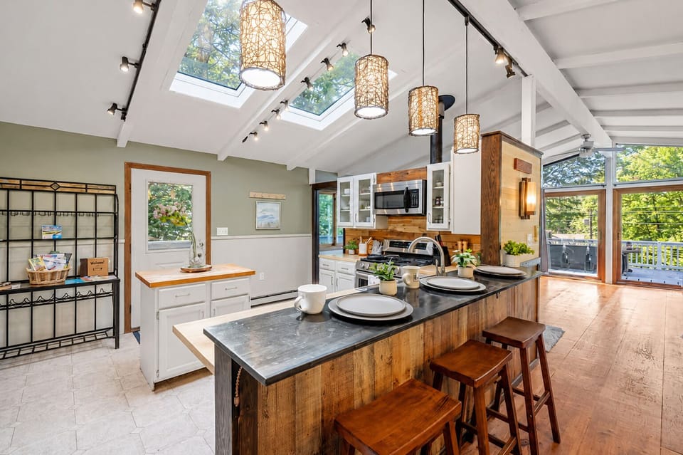 Open kitchen with butcher-block island, breakfast bar, and skylights
