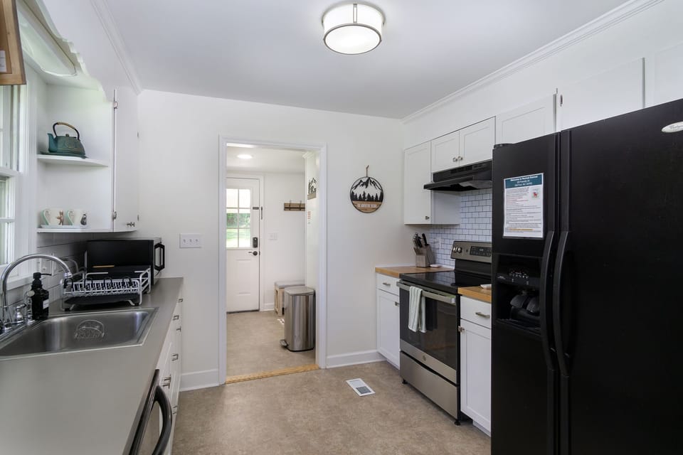 The main entrance and laundry room leads into the kitchen complete with a dishwasher and full coffee bar.