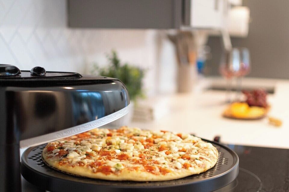 Slice of perfection: Craft your pizza with the Rotating Countertop Pizza Oven.