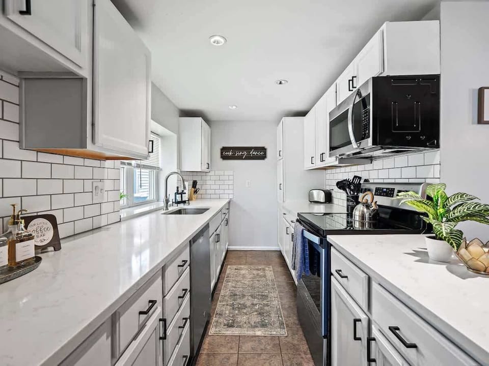 Cook like a pro in this sleek, modern kitchen featuring stainless steel appliances, spacious counters, and a charming coffee bar ☕ Everything you need for meals, snacks, and cozy mornings at home! 