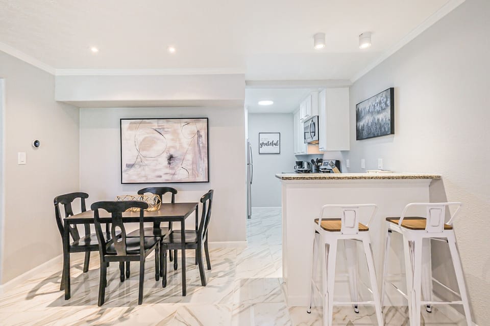 View from entrance of 2 dining areas and Kitchen