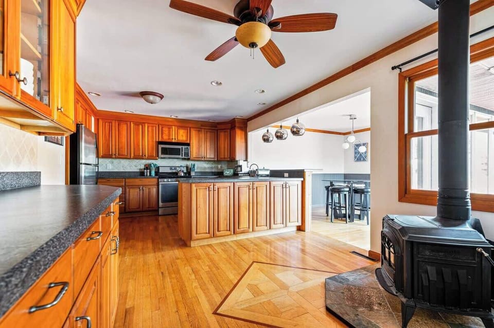 The spacious gourmet kitchen with a wood-burning stove.
