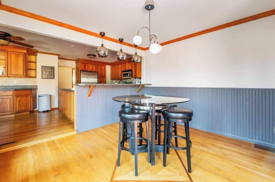 The kitchen opens to the dining area with a table for four.
