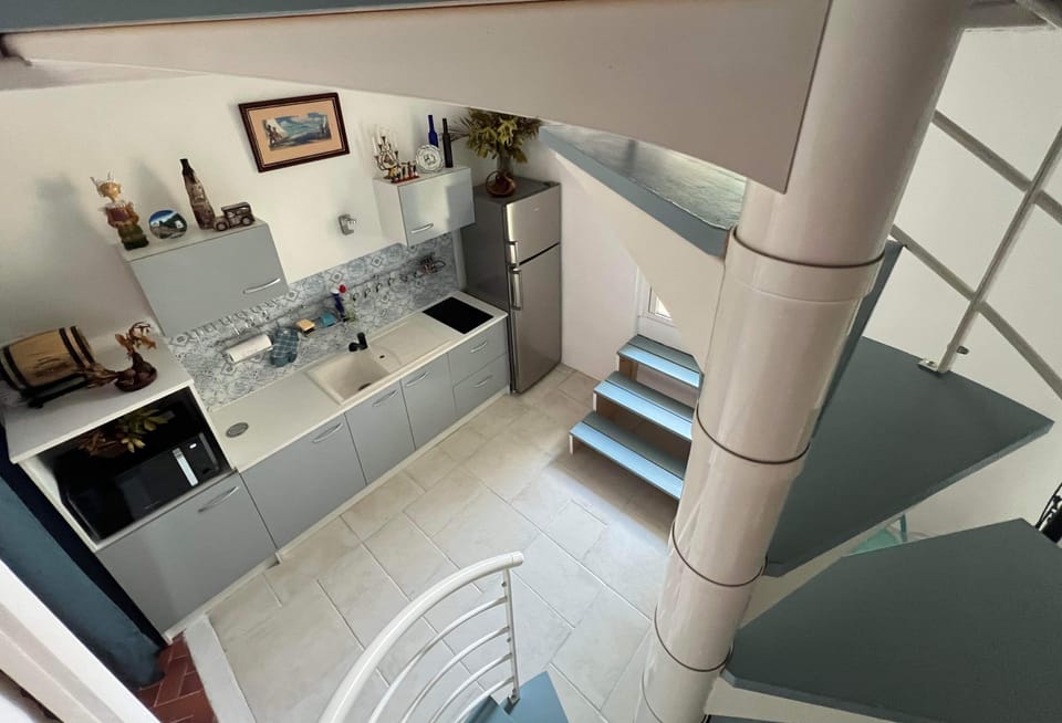 Kitchen and staircase to second bedroom