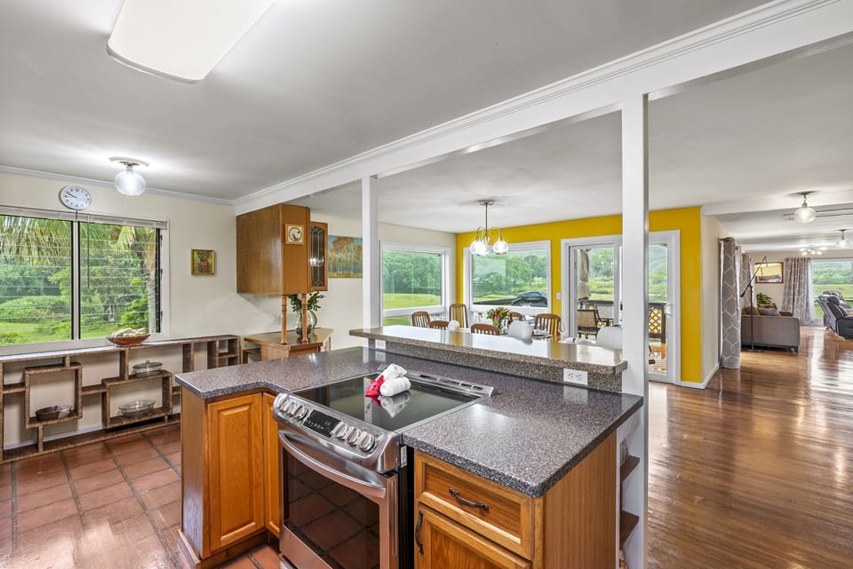 Cooking is a breeze in this spacious kitchen featuring panoramic views of the Koʻolau Mountains.
