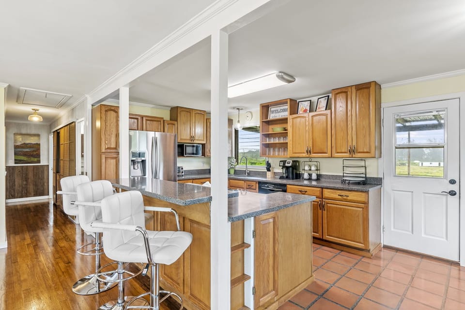 The open kitchen with bar seating invites everyone to Gather, cook, and connect with ease.