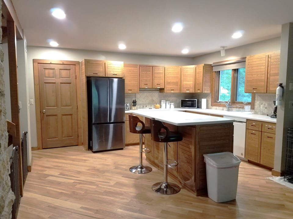 Kitchen, open to dining/living area.  Door leads to 4-Season room.