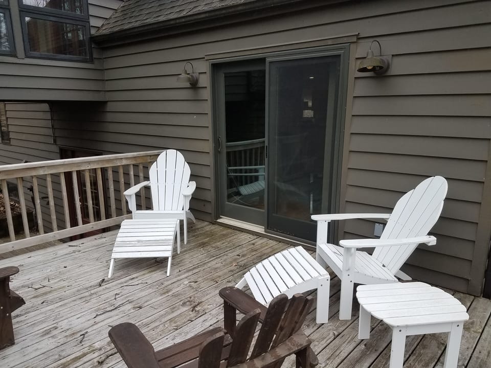 Deck with access to living room, front entrance, and bedrooms.