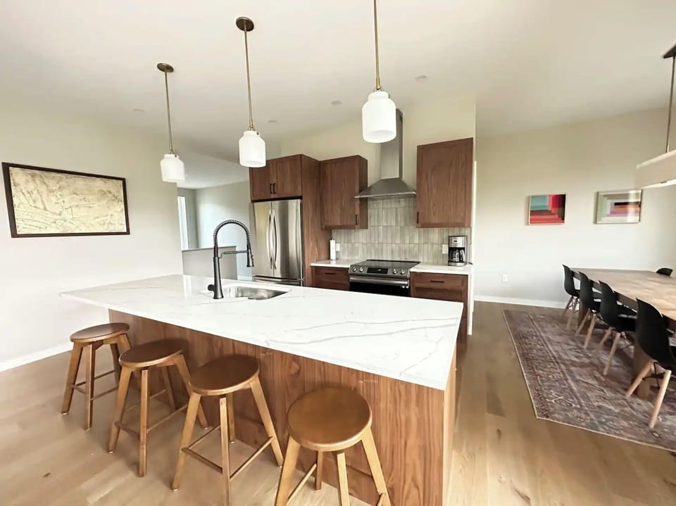 Kitchen island, stools and adjacent dining room