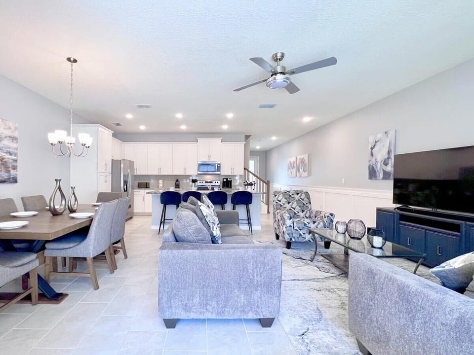 Gather in the inviting living room with comfortable furnishings, a large flat-screen TV, and complimentary high-speed Wi-Fi for entertainment and relaxation.