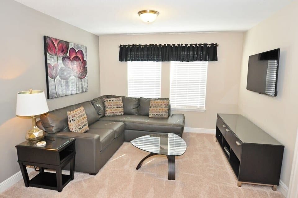 Gather in the inviting loft living area with comfortable furnishings, a large flat-screen TV, and complimentary high-speed Wi-Fi for entertainment and relaxation.