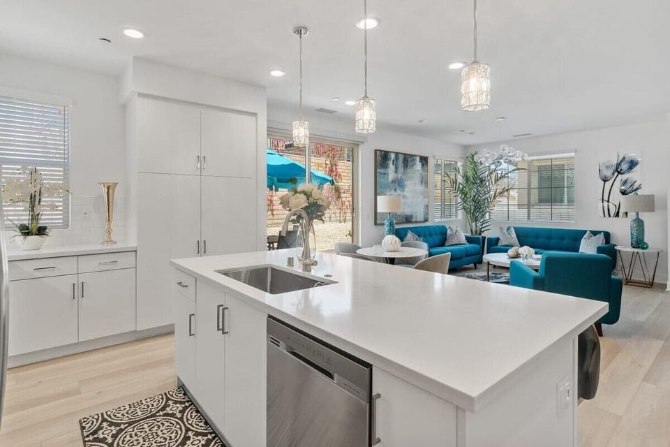 White cabinets and counters with views straight through to the living room.