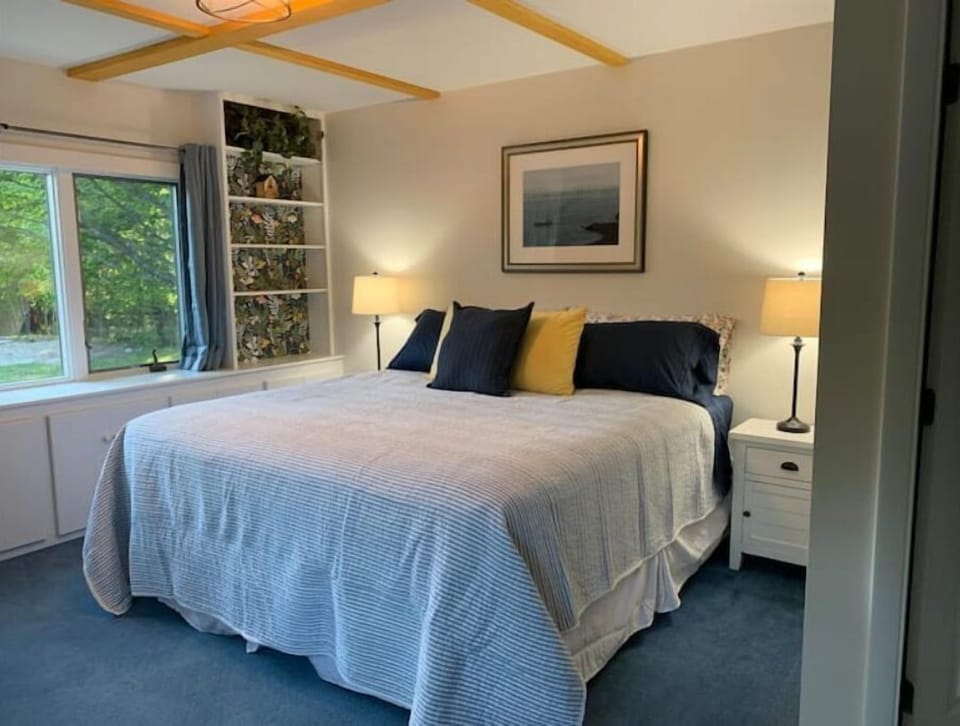 First floor bedroom with king bed and attached bathroom