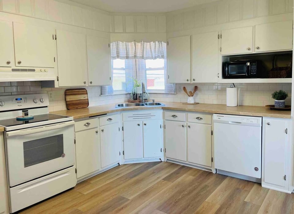 Lots of room in this kitchen for meal prep! Corner kitchen window overlooks the covered parking area and detached garage.