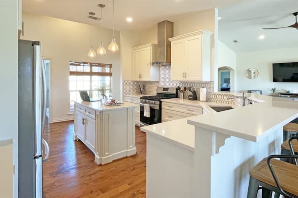 Fully stocked kitchen, gas stove, keurig, large fridge/freezer and bar seating.