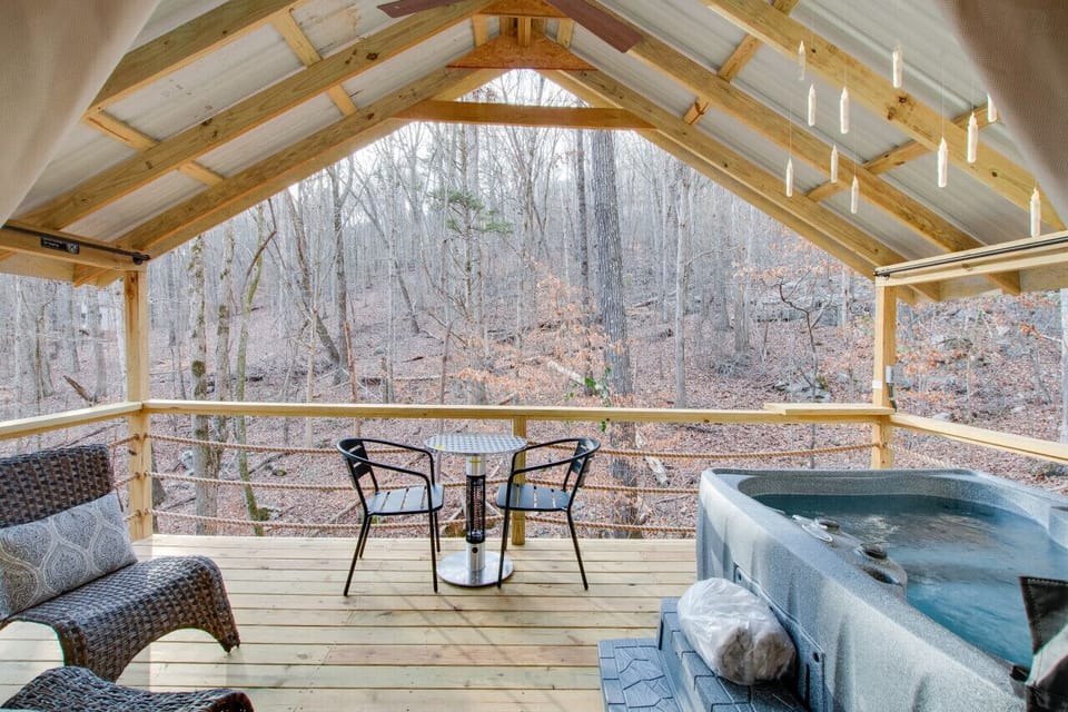 Spacious glamping tent featuring a private hot tub, king bed, and scenic views. Experience luxury camping in the heart of North Alabama.