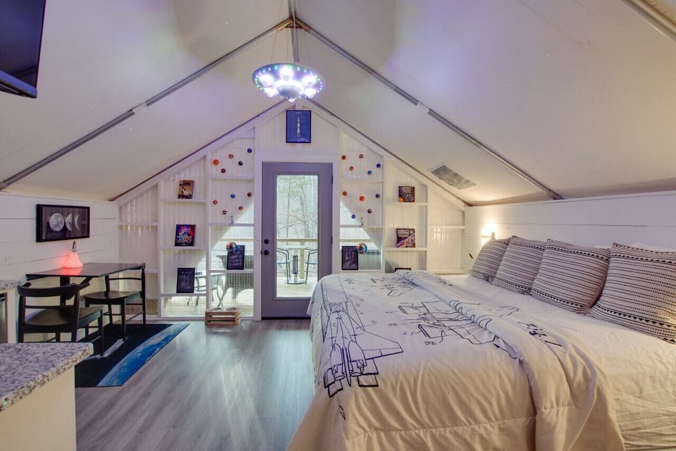 Spacious glamping tent featuring a King bed and a fully equipped kitchenette with a dishwasher, coffee maker, and everything you need for a convenient stay in the woods.