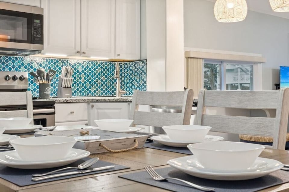 Dining table seats up to 6 guests with six bar stools surrounding the bar.