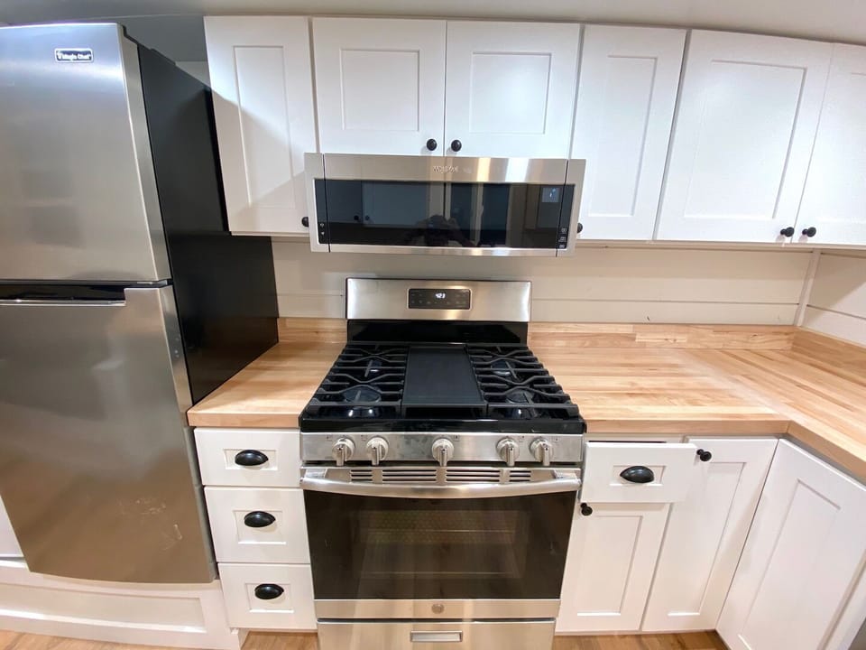 Beautiful wood counter tops line the counter. A full sized oven and stove provide a great place to whip up a tasty meal.