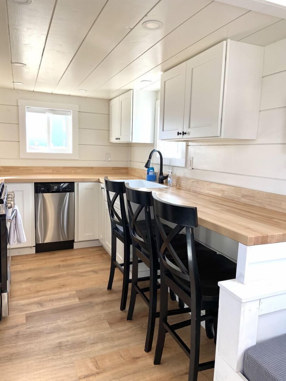 The bright kitchen is a nice large size considering it is in a tiny home!  There is even space for dining.
