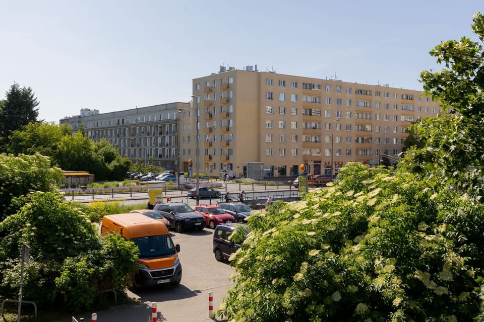 A pleasant city view of surrounding buildings and greenery, as seen from the apartment.