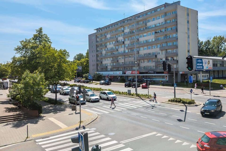 A lively view of the surrounding buildings and trees from the outside of the apartment.