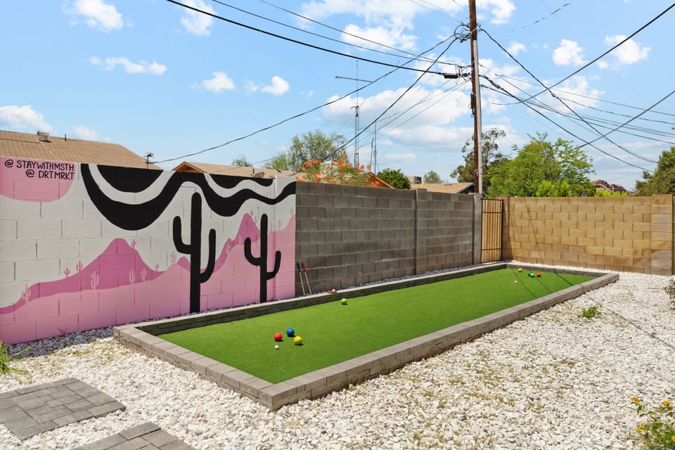 Enjoy this bocce ball and golf putting greein the back yard.