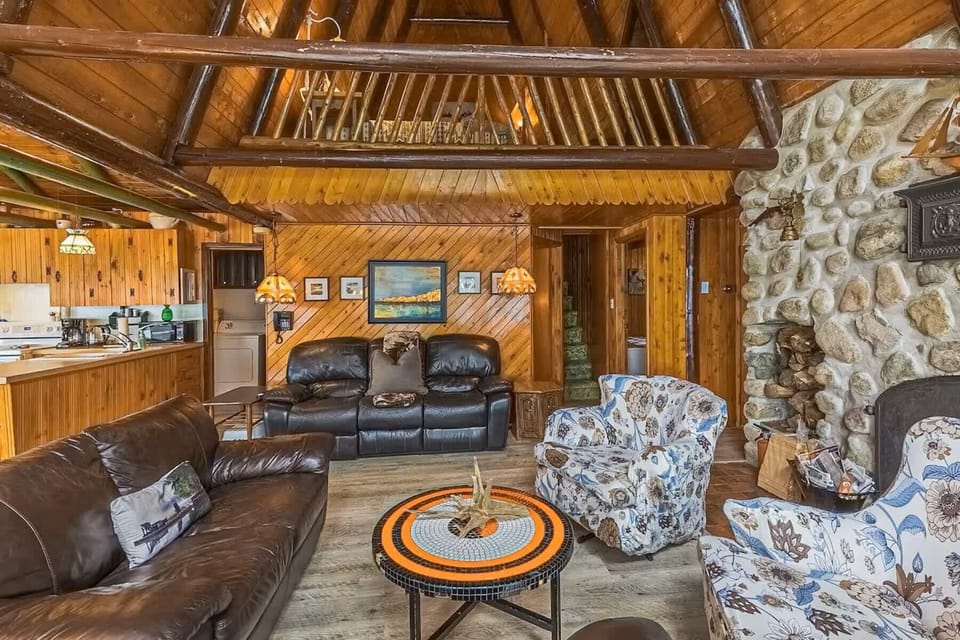 Rustic living room featuring comfy sofas and natural stone accents