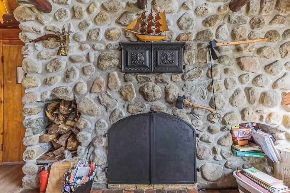 Traditional stone fireplace surrounded by cozy furnishings and decor