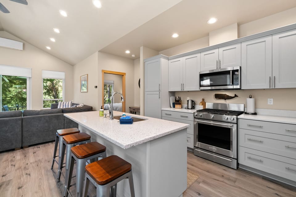 Beautiful kitchen with all new appliances, Gas range, dishwasher, Fridge, microwave, and breakfast bar.
