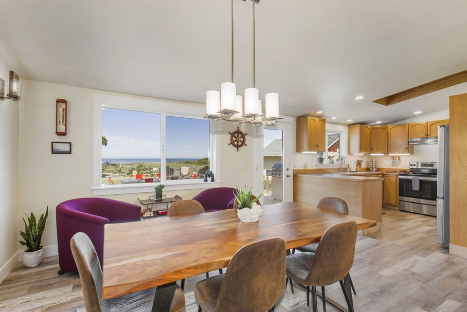 Dining room open to kitchen. High-quality live edge table with seating for 6 