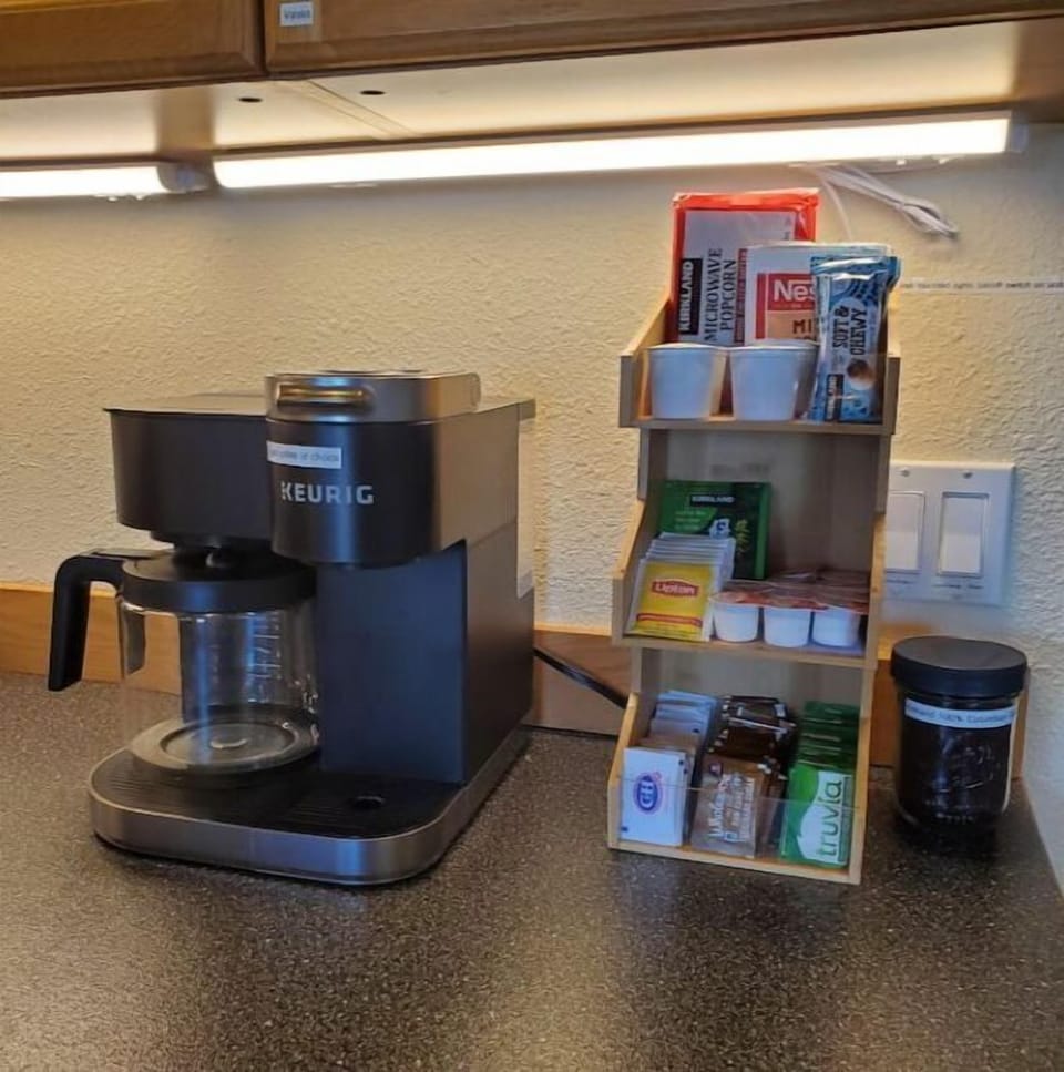 Coffee bar with ground coffee, pods, teas, hot chocolate, popcorn, bars