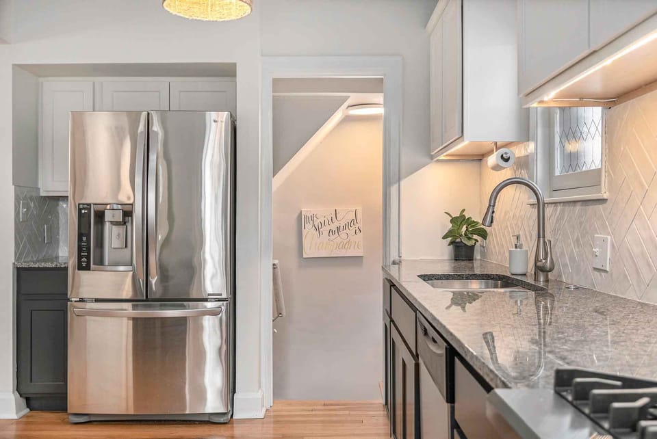 A stairwell in the kitchen leads to the downstairs living space