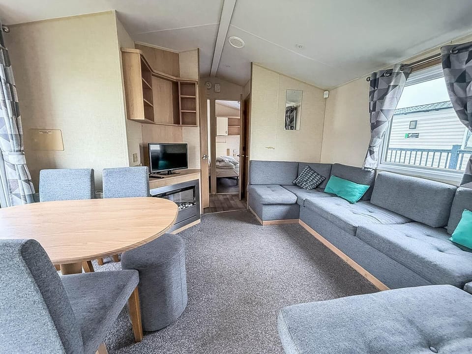 Step into the spacious living room of your caravan, designed for relaxation