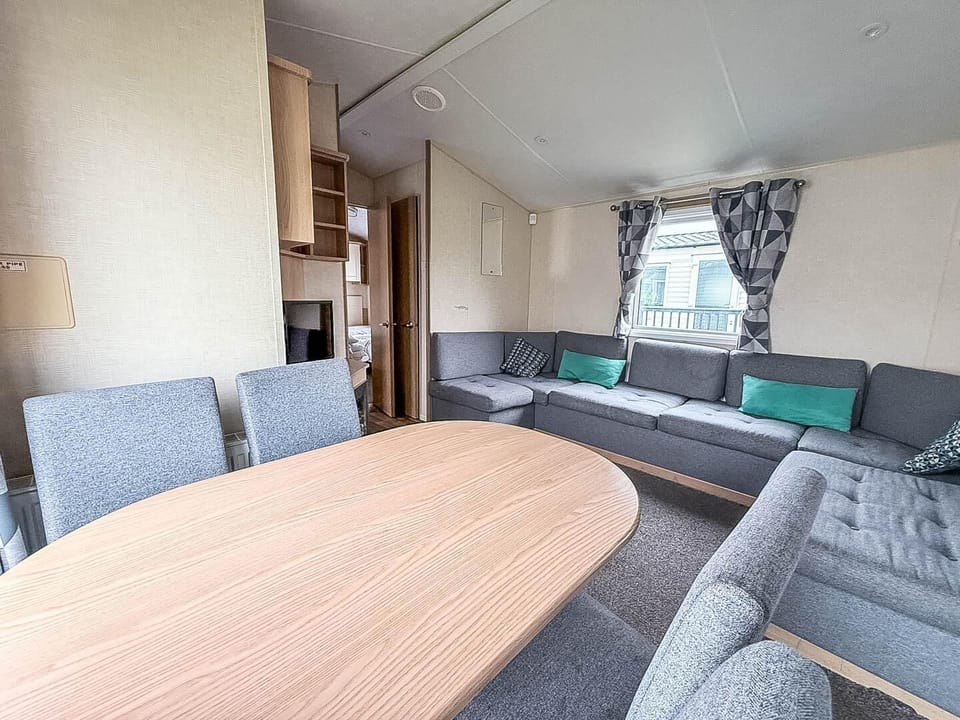 Living room is thoughtfully designed, offering a cosy space to unwind with the family after a fun-filled day by the seaside.