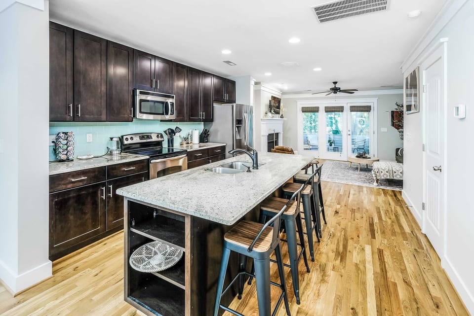 A beautifully designed kitchen and dining area featuring modern appliances, ample counter space, and a welcoming dining setup—perfect for cooking and gathering with friends or family.